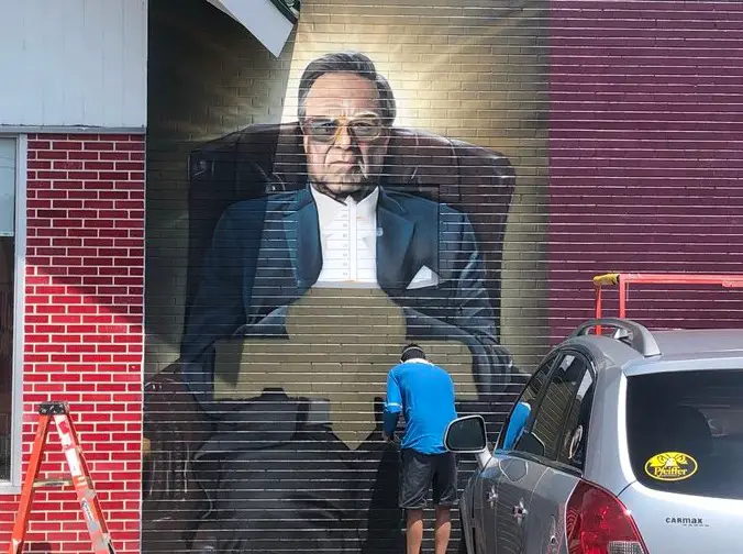 An artist named Douglas Panzone is painting a mural in Avondale